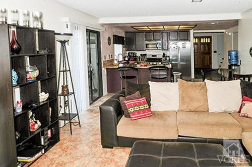 3636 Olds Road Oxnard, CA 93033 - Photo 12 of 23 a living room with furniture a flat screen tv and a refrigerator