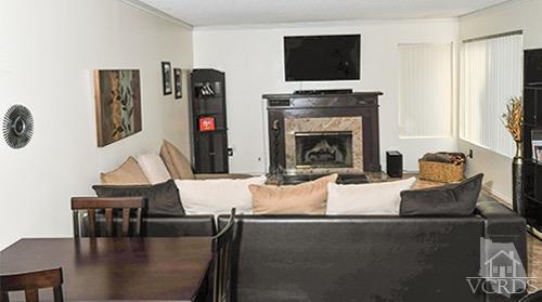 3636 Olds Road Oxnard, CA 93033 - Photo 8 of 23 a living room with furniture a flat screen tv and a fireplace