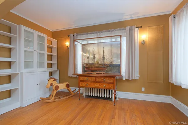 a view of a room with wooden floor and furniture