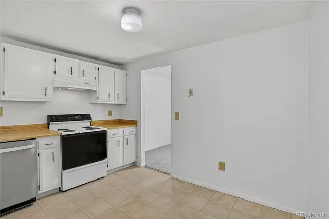 a kitchen with cabinets and white stainless steel appliances