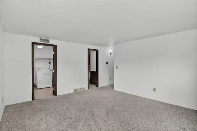 a view of an empty room and closet area