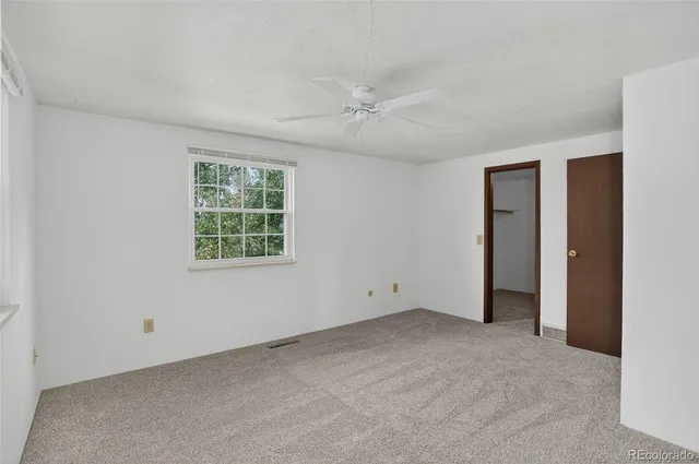 an empty room with windows and closet