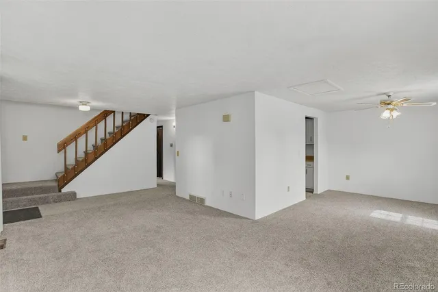 a view of an empty room with stairs