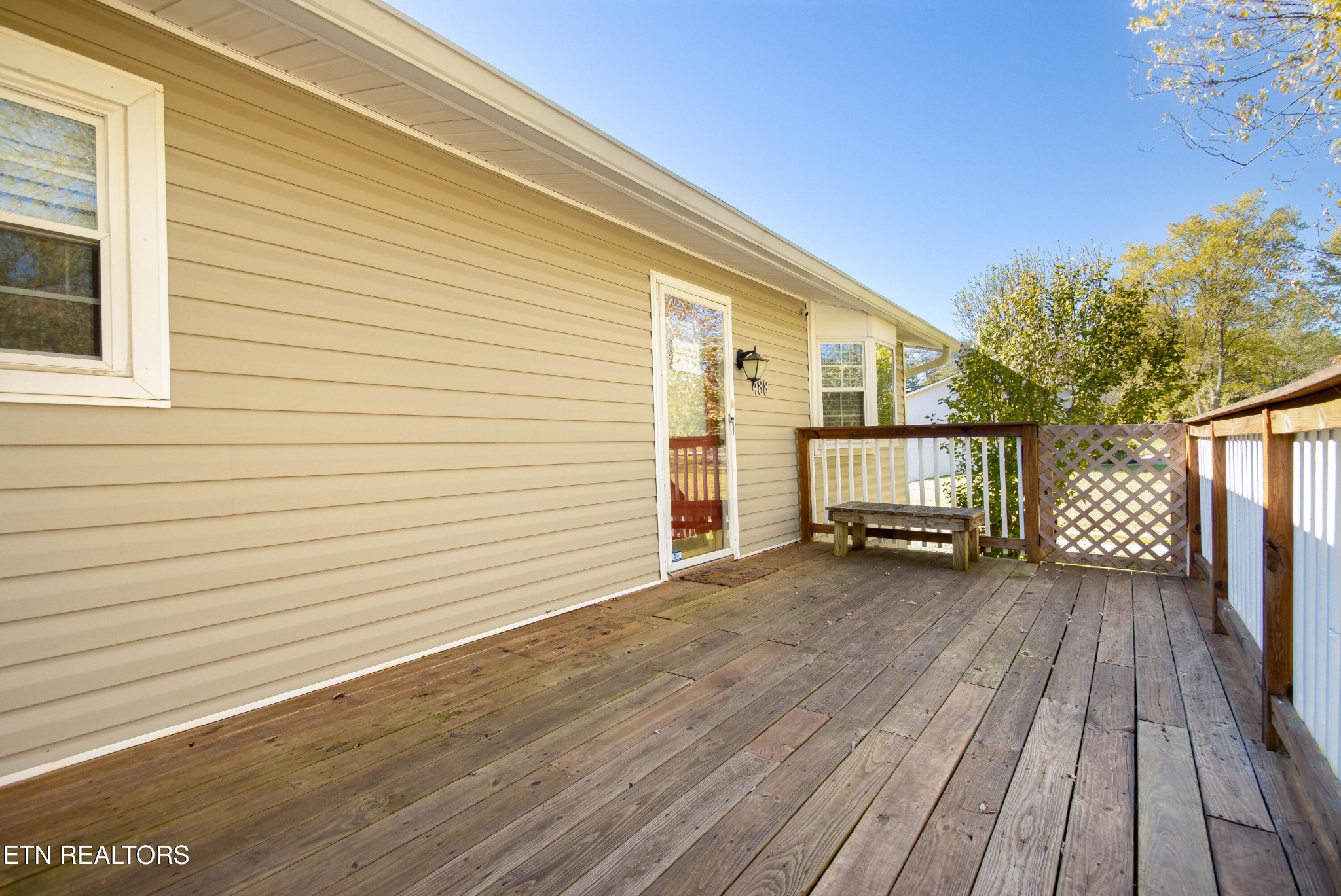 488 Raccoon Valley Road Powell, TN 37849 - Photo 3 of 24 a view of front door deck and barbeque with wooden fence