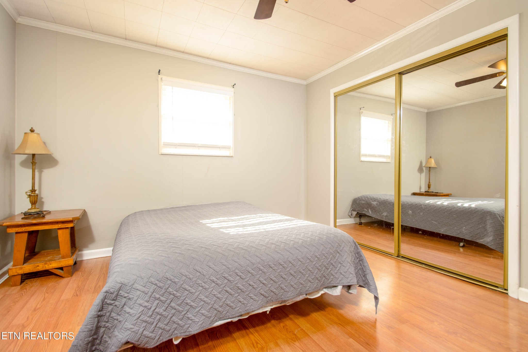 488 Raccoon Valley Road Powell, TN 37849 - Photo 10 of 24 a bedroom with a bed and a lamp next to a window