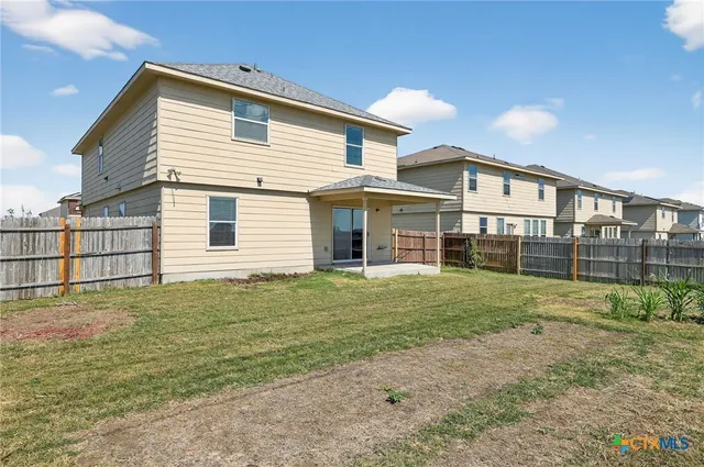 a view of a house with a backyard