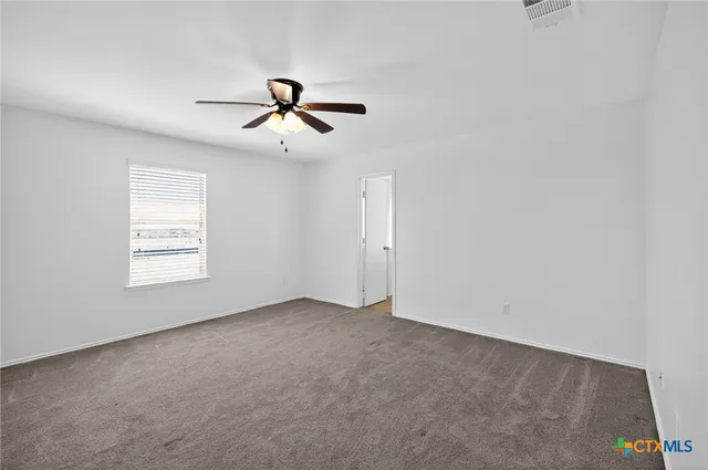 a view of room with a ceiling fan and window