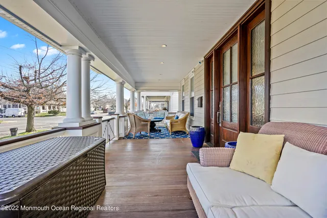 a living room with furniture and large windows
