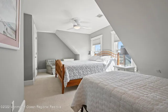 a bedroom with two beds and a chandelier