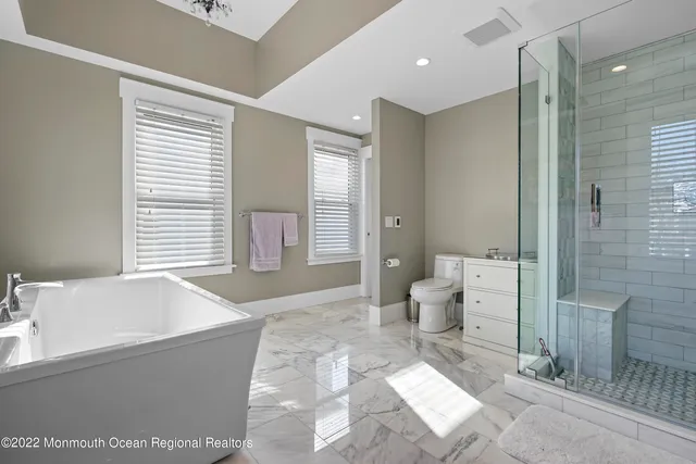 a spacious bathroom with a bathtub sink and toilet