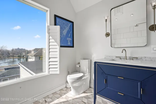 a bathroom with a toilet sink and mirror
