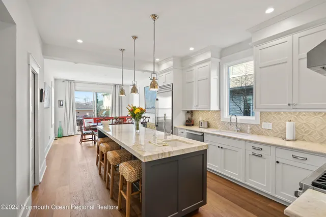 a kitchen with sink stove and cabinets