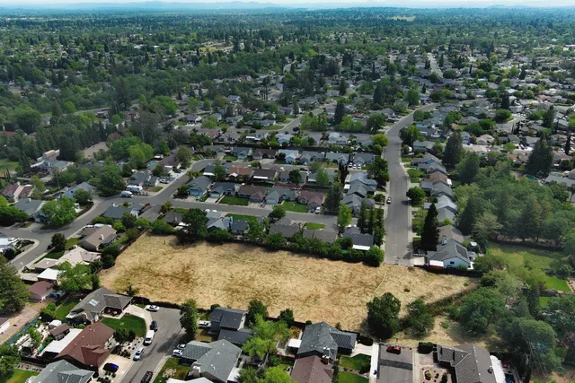 an aerial view of residential houses with outdoor space