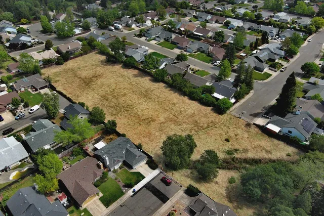 an aerial view of a house with yard