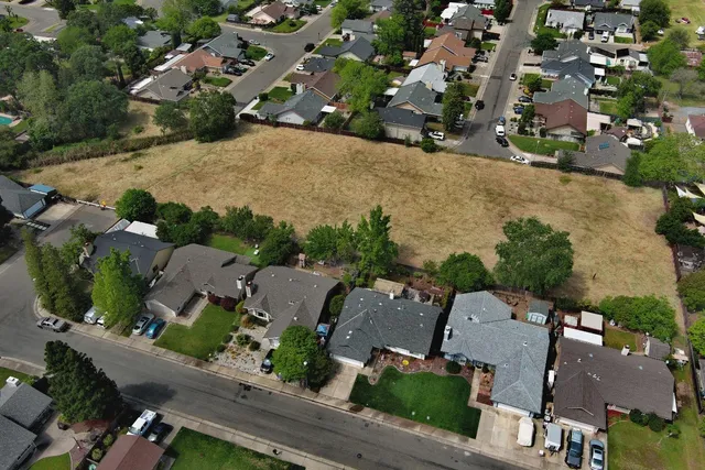an aerial view of a city with lots of residential buildings and parking space
