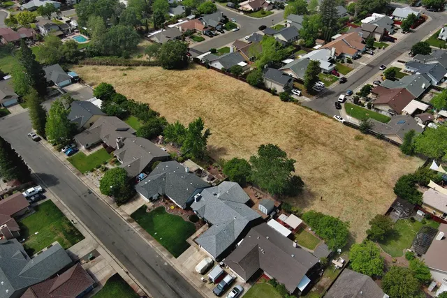 an aerial view of residential houses with outdoor space