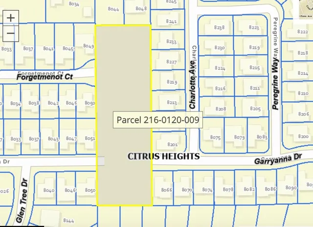 a sign on a street next to a glass door