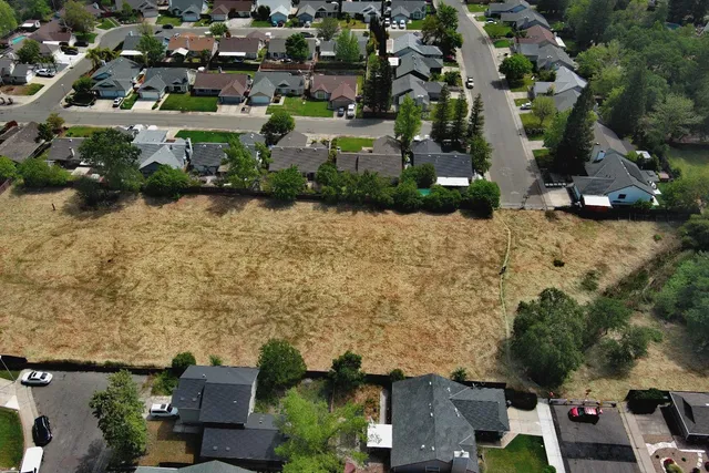 an aerial view of a house with a yard