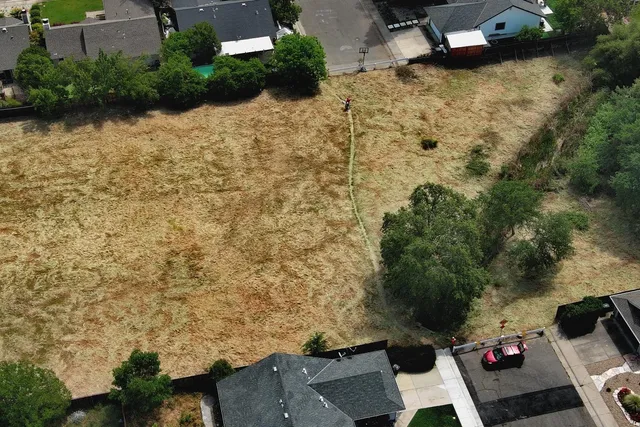 an aerial view of residential houses with outdoor space