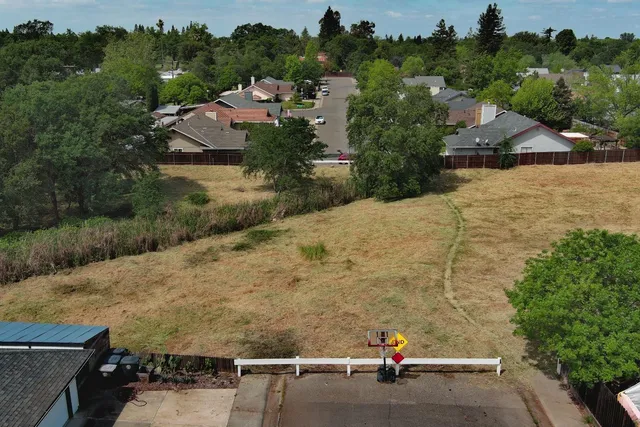 an aerial view of a house with a garden and parking space