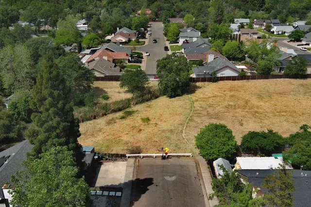 an aerial view of a house with a garden and street view