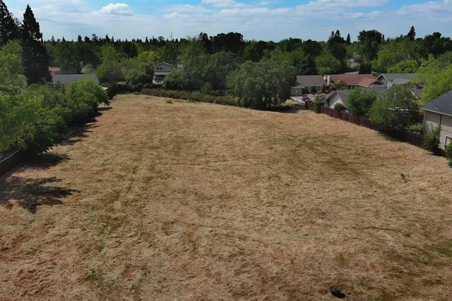 an aerial view of a house with garden space and street view