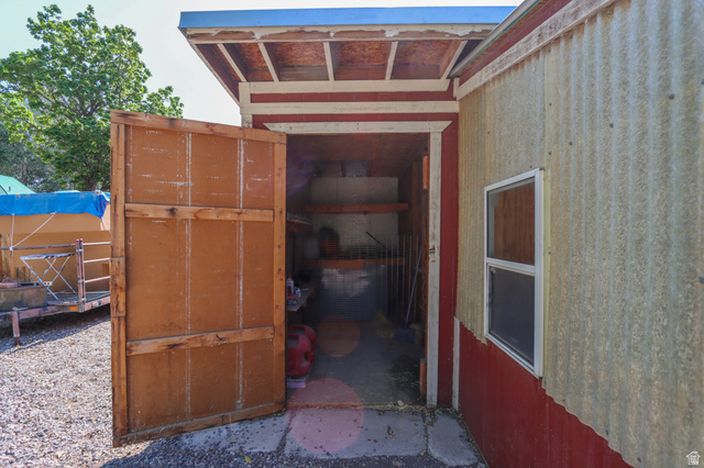 270 East 100 North Monroe, UT 84754 - Photo 51 of 65 Outbuilding featuring a corrugated metal exterior, red trim accents, and a single-pane window