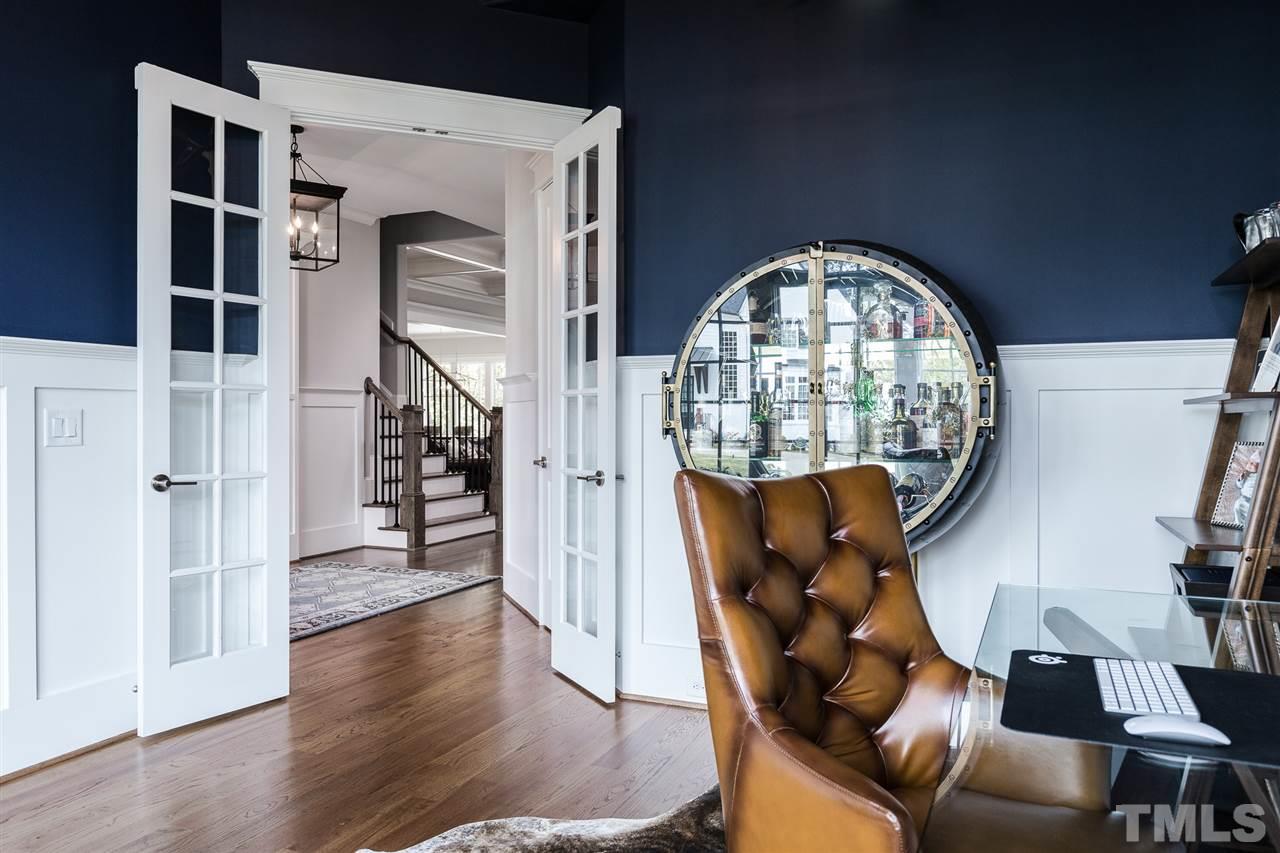 5417 Winding View Lane Raleigh, NC 27615 - Photo 12 of 30 Overlooking the front of the home, this downstairs office features detailed wainscoting and French doors.