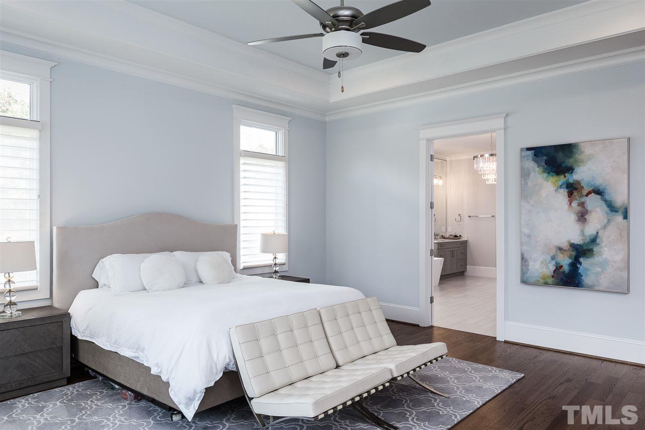 5417 Winding View Lane Raleigh, NC 27615 - Photo 14 of 30 Large and airy, the primary bedroom has gorgeous hardwoods and overlooks the backyard.