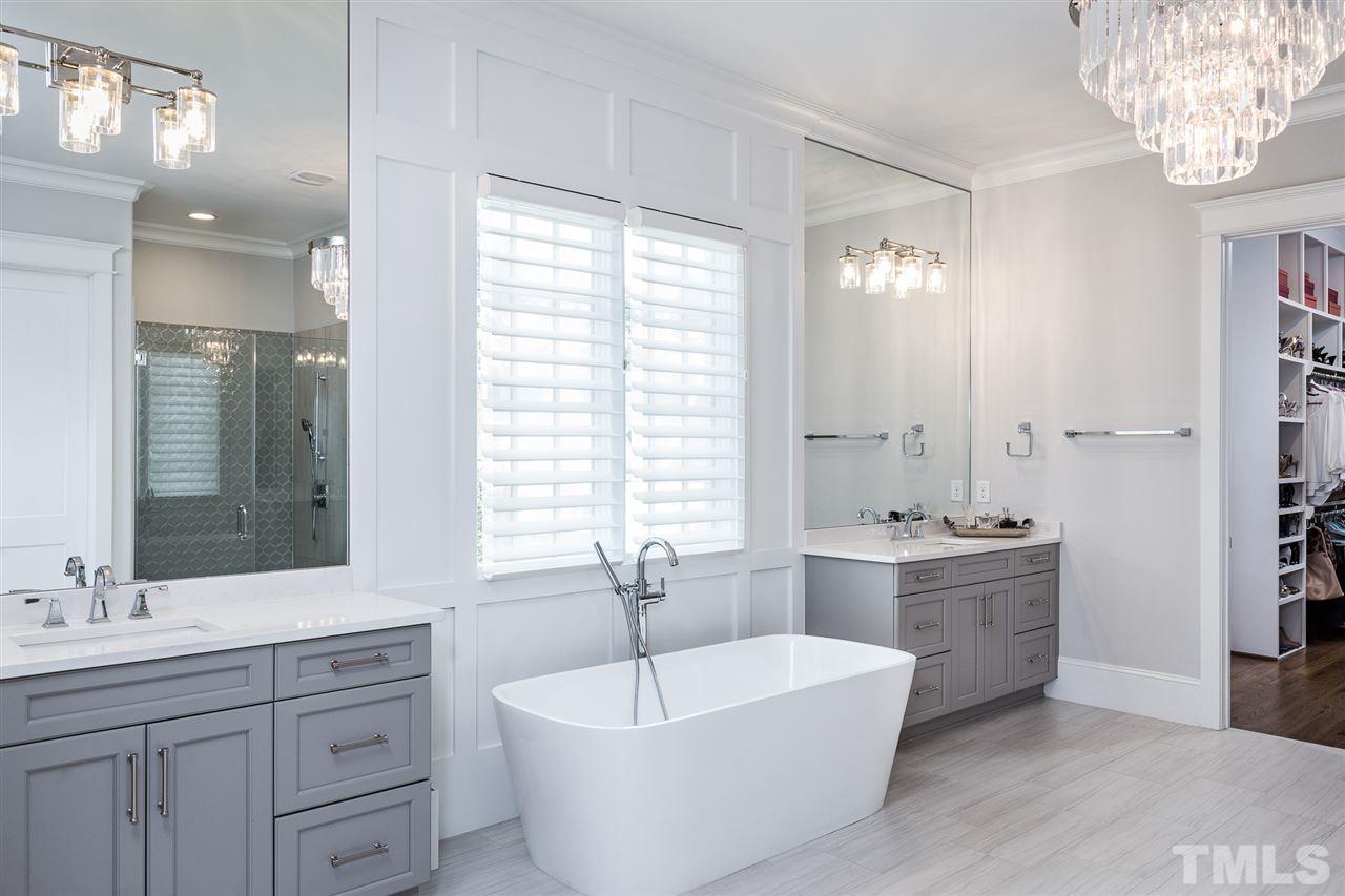 5417 Winding View Lane Raleigh, NC 27615 - Photo 15 of 30 Enjoy the dual vanities, large soaking tub, and sophisticated details in this downstairs bath/spa.