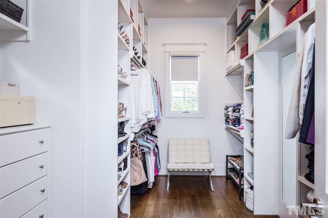 5417 Winding View Lane Raleigh, NC 27615 - Photo 17 of 30 One of two primary walk-in closets with custom shelving.