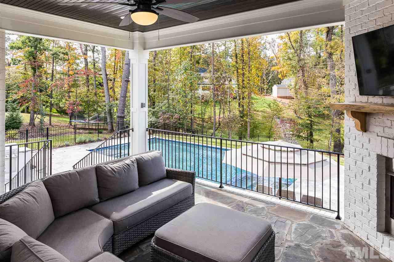 5417 Winding View Lane Raleigh, NC 27615 - Photo 27 of 30 Lovely veranda, accessible from a multi-slide glass door, overlooks the stunning salt water pool and jacuzzi.