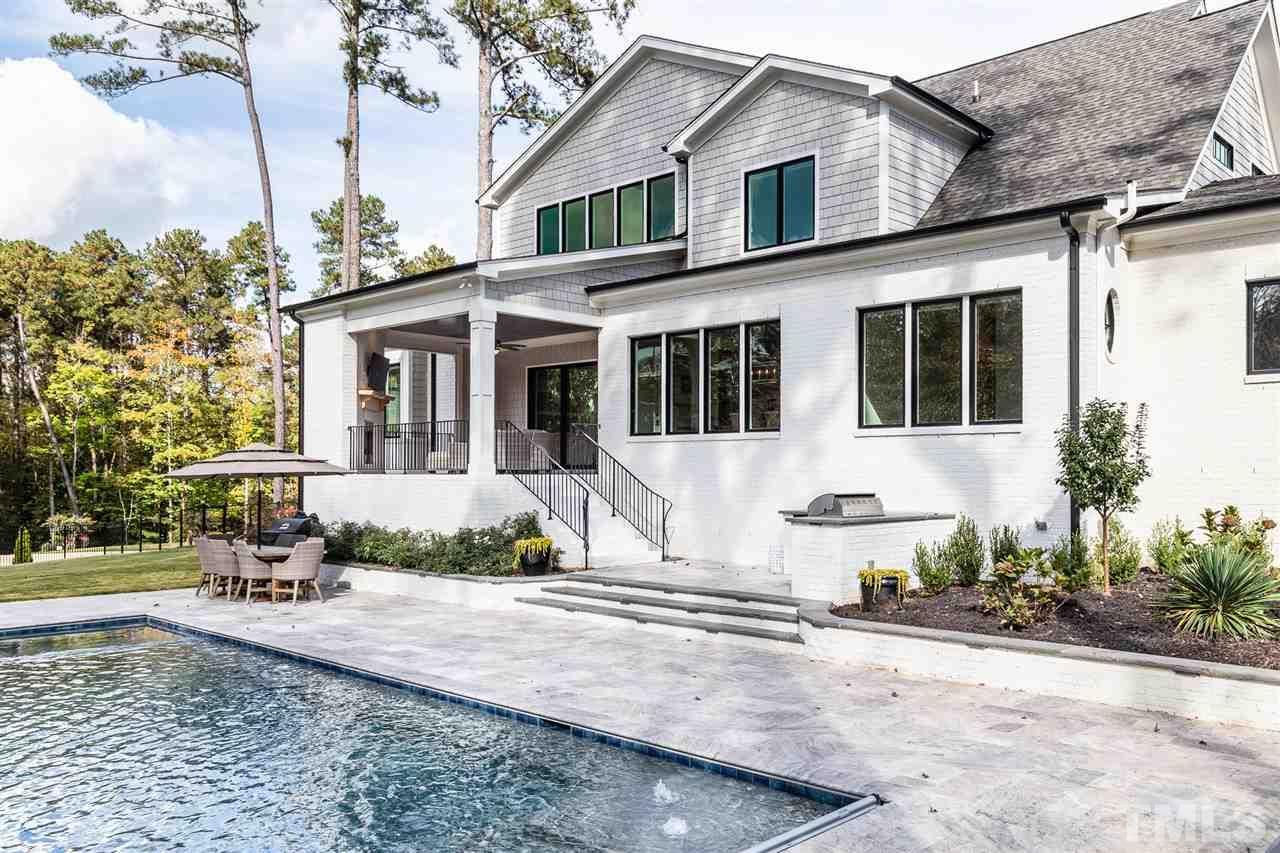 5417 Winding View Lane Raleigh, NC 27615 - Photo 29 of 30 Travertine tile, built-in grill, outdoor refrigerator, salt water pool and jacuzzi with retractable cover. This is the backyard dreams are made of.
