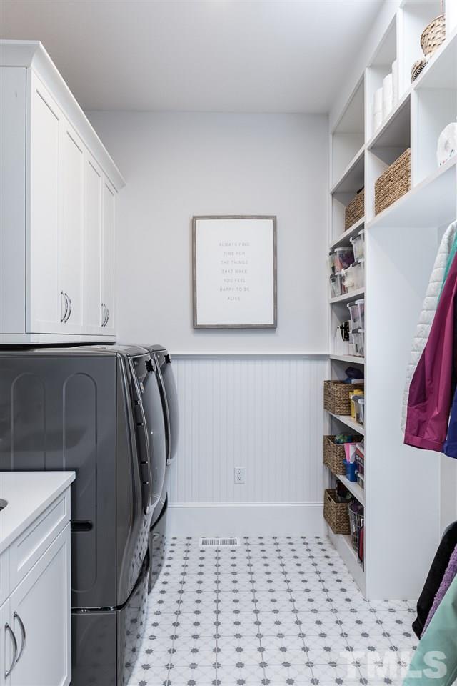 5417 Winding View Lane Raleigh, NC 27615 - Photo 7 of 30 One of two laundry rooms - the second is upstairs - this functional room has plenty of storage and a spot for a second refrigerator.