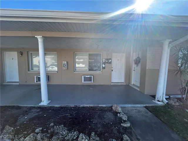 a view of empty room with wooden floor and window