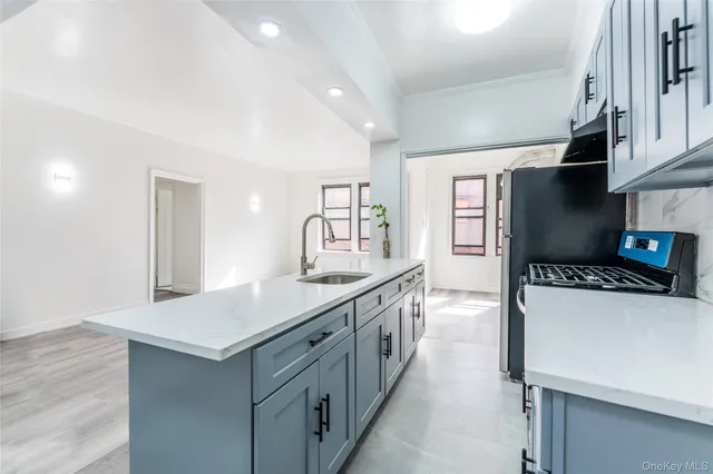 a kitchen with a stove a sink and a refrigerator