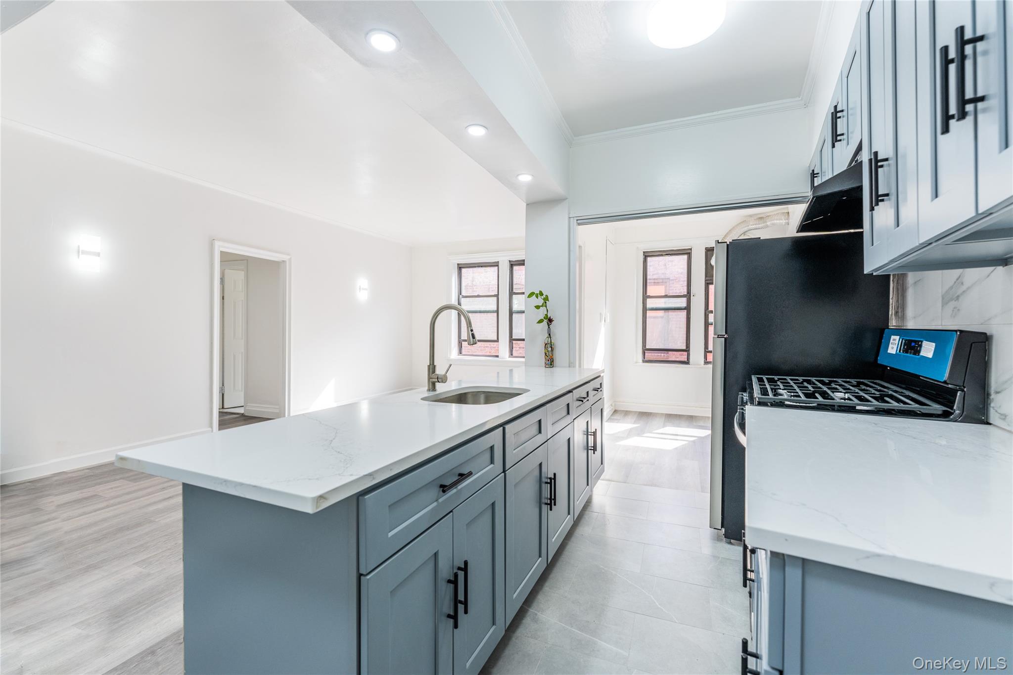 136-05 Sanford Avenue, Unit 6S Queens, NY 11355 - Photo 5 of 15 a kitchen with a stove a sink and a refrigerator