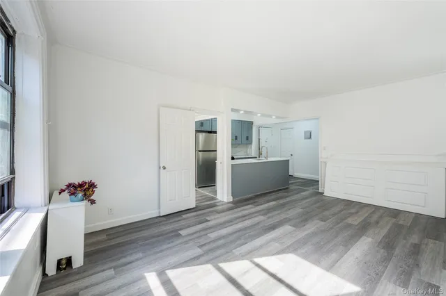 a view of a room with wooden floor and white walls