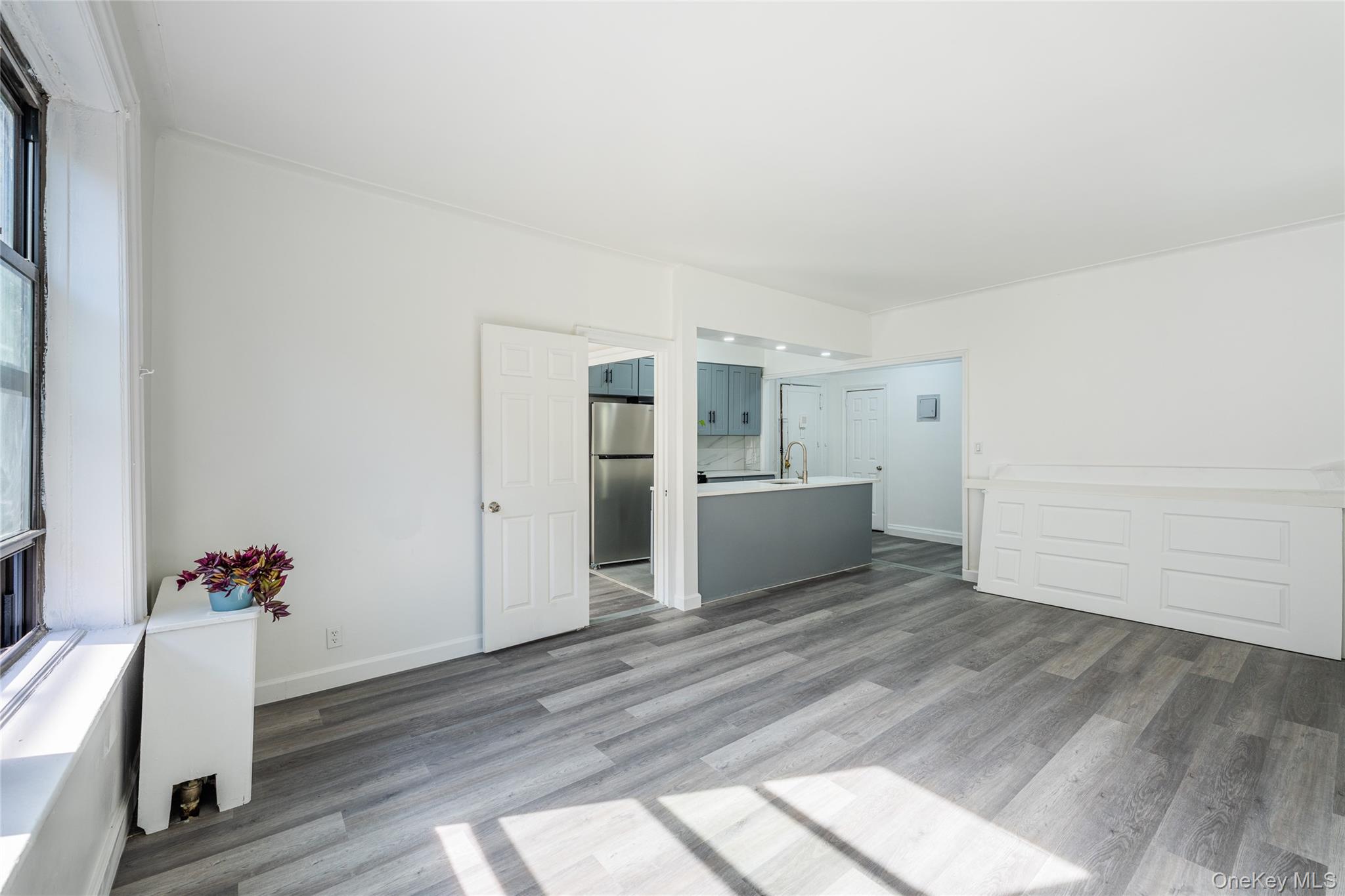 136-05 Sanford Avenue, Unit 6S Queens, NY 11355 - Photo 7 of 15 a view of a room with wooden floor and white walls