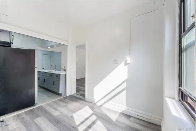 a view of a kitchen with refrigerator and more windows