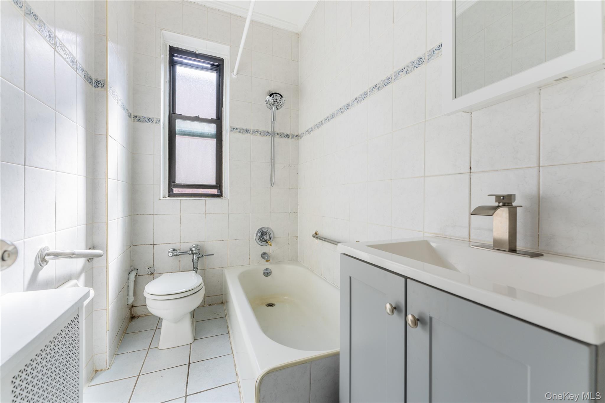 136-05 Sanford Avenue, Unit 6S Queens, NY 11355 - Photo 10 of 15 a bathroom with a sink toilet and shower