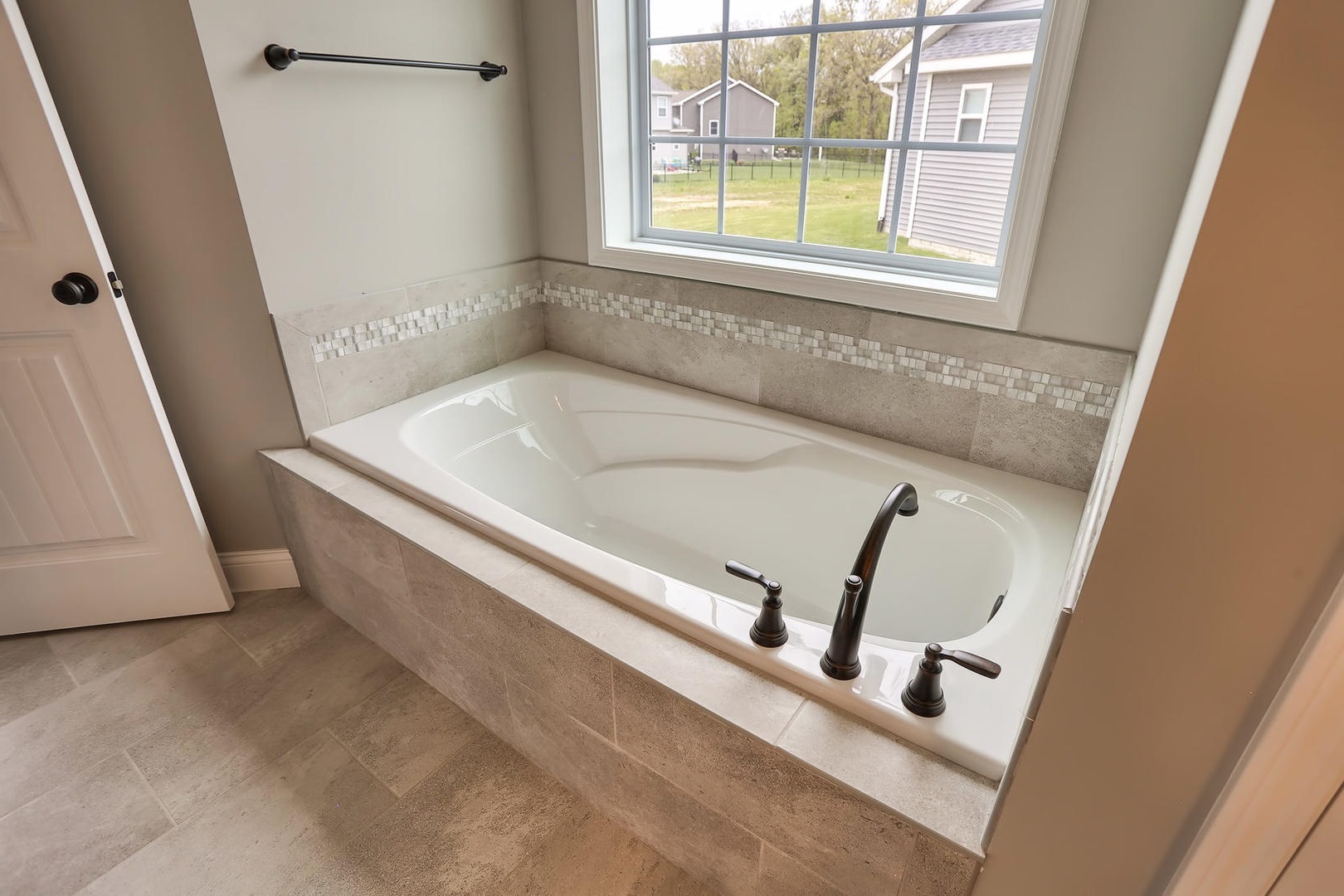 303 Collins Drive Mahomet, IL 61853 - Photo 15 of 32 a bathroom with a tub sink and a window