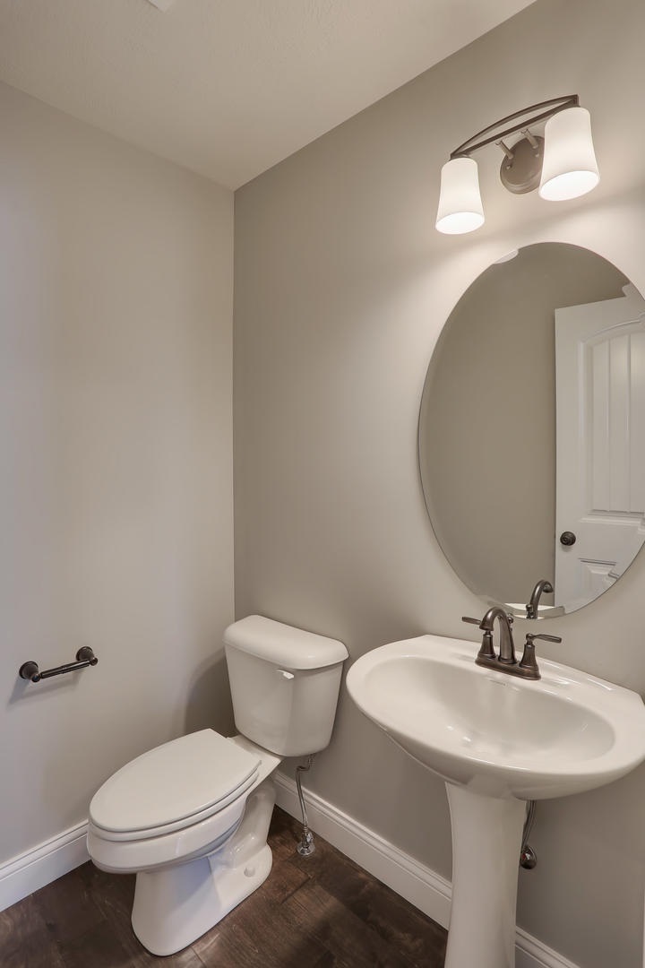 303 Collins Drive Mahomet, IL 61853 - Photo 17 of 32 a bathroom with a toilet a sink and mirror