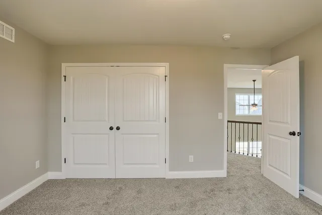 a view of an empty room and a bathroom