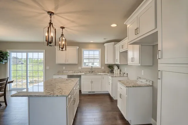 a kitchen with a sink stove and cabinets