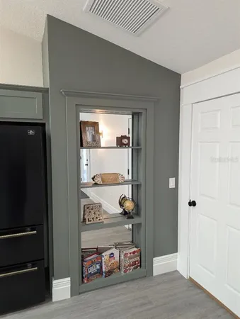 a view of a hallway to a livingroom and a couch