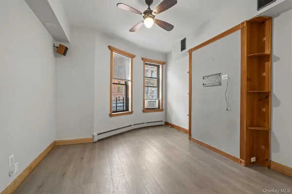 wooden floor in an empty room with a window