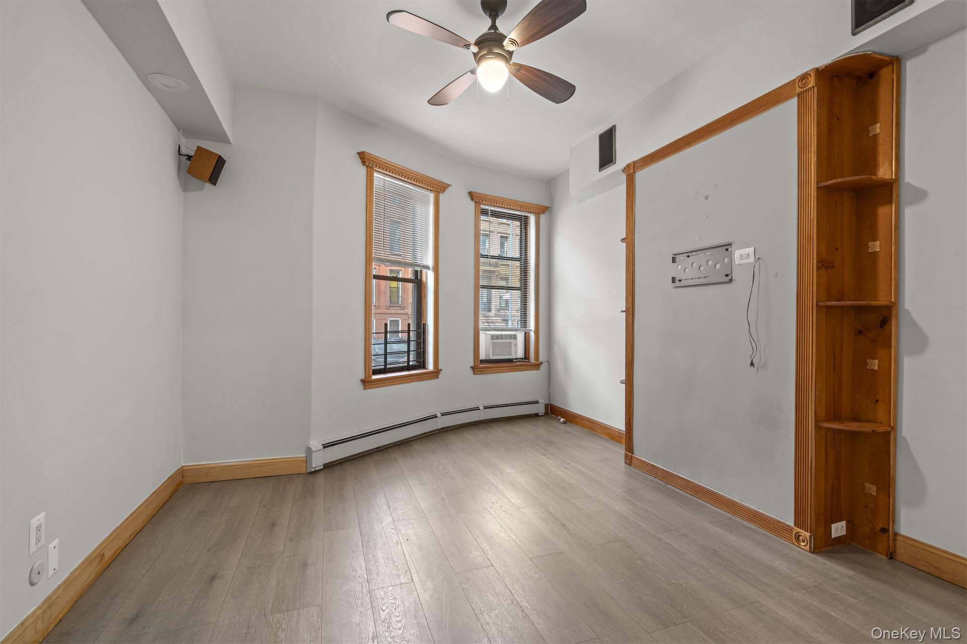44 Decatur Street, Unit 2 Brooklyn, NY 11216 - Photo 6 of 8 wooden floor in an empty room with a window