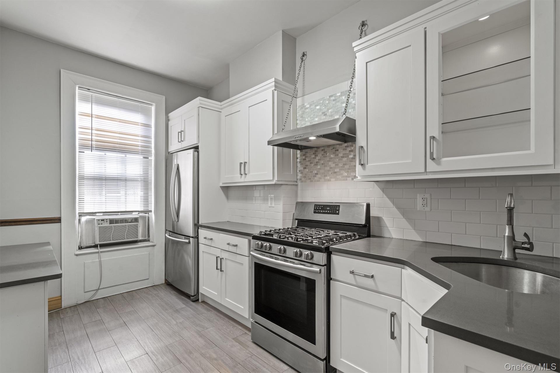 44 Decatur Street, Unit 2 Brooklyn, NY 11216 - Photo 7 of 8 a kitchen with stainless steel appliances granite countertop a refrigerator and a stove top oven