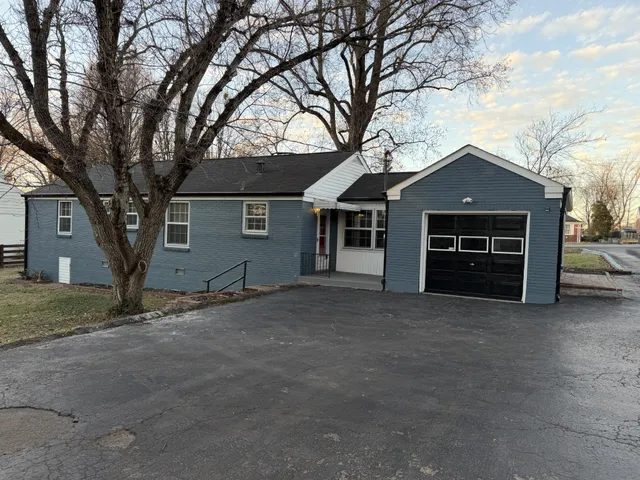 a view of a kitchen with a sink and a refrigerator